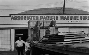 Associated Pacific Machine Corp. Early photo of APMC building and workers. 