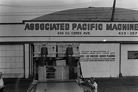 Die cutting machinery. Early photo of Associated Pacific Machine Corp.